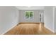 Bright living room with hardwood floors, a large window, and neutral walls at 103 Kylie Savannah Ct, Cary, NC 27511