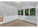 Sun room with wood floors, paneled walls, multiple windows and exterior door at 103 Kylie Savannah Ct, Cary, NC 27511