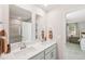 Modern bathroom features double sinks with white countertops and cabinets and large mirrors above at 1037 Winding Spring Dr, Mebane, NC 27302