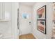 Bright entryway features a glass door, white walls, and modern decorative artwork at 1037 Winding Spring Dr, Mebane, NC 27302