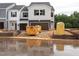 New two-story townhouse with a garage, situated in a residential community undergoing construction at 1037 Winding Spring Dr, Mebane, NC 27302