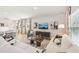Spacious living room featuring a white sofa, accent chair, contemporary furnishings, and hardwood floors at 1037 Winding Spring Dr, Mebane, NC 27302