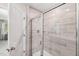 Modern bathroom features a tiled shower with a glass door, a shower head, and a white door at 1037 Winding Spring Dr, Mebane, NC 27302