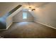 Spacious attic space featuring neutral walls, carpeted floors, a ceiling fan, and a window at 108 W Marsha Gayle Ct, Fuquay Varina, NC 27526