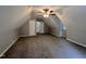 Spacious attic space featuring neutral walls, carpeted floors, and a ceiling fan at 108 W Marsha Gayle Ct, Fuquay Varina, NC 27526