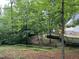 Spacious backyard with mature trees and a glimpse of the home's exterior at 108 W Marsha Gayle Ct, Fuquay Varina, NC 27526