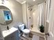 Cozy bathroom featuring a walk-in shower, a sink, and wood-look vinyl flooring at 108 W Marsha Gayle Ct, Fuquay Varina, NC 27526
