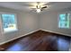 This bedroom features hardwood floors and two windows with natural light at 108 W Marsha Gayle Ct, Fuquay Varina, NC 27526