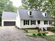 Charming home with white siding, black shutters, a gravel driveway, and beautiful landscaping at 108 W Marsha Gayle Ct, Fuquay Varina, NC 27526