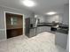 Modern kitchen featuring stainless steel appliances, stylish tile flooring, and grey cabinets at 108 W Marsha Gayle Ct, Fuquay Varina, NC 27526