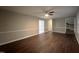 Living room featuring wood-look floors, neutral walls, white trim, and access to other areas at 108 W Marsha Gayle Ct, Fuquay Varina, NC 27526