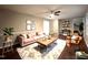 Inviting living room featuring hardwood floors, a ceiling fan, and ample natural light at 108 W Marsha Gayle Ct, Fuquay Varina, NC 27526