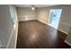 Living room featuring wood-look floors, neutral walls, white trim, and access to other areas at 108 W Marsha Gayle Ct, Fuquay Varina, NC 27526