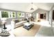 Bright open living room with white tile floors, a vaulted ceiling, and lots of windows at 108 W Marsha Gayle Ct, Fuquay Varina, NC 27526