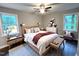 Relaxing main bedroom featuring natural light, neutral tones, and hardwood floors at 108 W Marsha Gayle Ct, Fuquay Varina, NC 27526