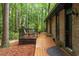 Exterior showing a back deck area with seating and access to the house, surrounded by lush greenery and trees at 109 Loch Haven Ln, Cary, NC 27518