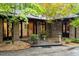 Close-up of the home's front entrance, highlighting the brick facade, mature landscaping, and stylish front door at 109 Loch Haven Ln, Cary, NC 27518