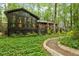 The exterior features a charming sunroom and deck, surrounded by lush greenery, offering serene outdoor living spaces at 109 Loch Haven Ln, Cary, NC 27518
