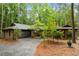 Beautiful brick home featuring a paved driveway, attached garage, and surrounding mature trees for privacy at 109 Loch Haven Ln, Cary, NC 27518