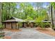 Charming brick home with mature trees, lush landscaping, and a paved driveway creating a welcoming curb appeal at 109 Loch Haven Ln, Cary, NC 27518