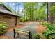 Landscaped front yard featuring a bench, lush greenery, and a stone-paved driveway leading to the house at 109 Loch Haven Ln, Cary, NC 27518