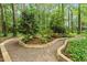 A peaceful garden path winds through the trees, inviting one to relax and enjoy the natural surroundings at 109 Loch Haven Ln, Cary, NC 27518