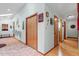 Long hallway with neutral walls and a mix of wood and tile floors at 109 Loch Haven Ln, Cary, NC 27518