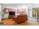 Cozy living room featuring hardwood floors, a TV, and comfortable seating with natural light from the windows at 109 Loch Haven Ln, Cary, NC 27518