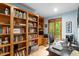 A dedicated home office with custom-built wooden bookshelves and an abundance of natural light at 109 Loch Haven Ln, Cary, NC 27518