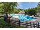 Large community swimming pool with lane markers surrounded by lounge chairs and mature trees at 109 Loch Haven Ln, Cary, NC 27518
