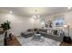 Inviting living room featuring natural light, a decorative rug, a comfortable sectional, and a statement wall at 1111 Cosmic Dr, Durham, NC 27703