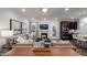 Inviting living room with a fireplace, dark cabinets, and an open layout to the kitchen and eat-in dining area at 1111 Cosmic Dr, Durham, NC 27703