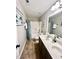 Well-lit bathroom with dual sinks, framed mirror, and tub with shower at 1116 Powder, Fuquay Varina, NC 27526