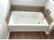 Bathroom featuring a soaking tub and tiled surround at 1116 Powder, Fuquay Varina, NC 27526