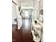 Inviting hallway with hardwood floors, stylish decor, and a glimpse into the bright living room, creating a warm welcome at 1116 Powder, Fuquay Varina, NC 27526