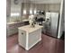 Eat-in kitchen featuring granite countertops, stainless appliances, and wood flooring at 1116 Powder, Fuquay Varina, NC 27526
