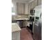 Close up of eat-in kitchen featuring stainless appliances, granite countertops, and wood flooring at 1116 Powder, Fuquay Varina, NC 27526