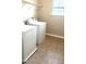 Laundry area with washer and dryer, window, and tile flooring at 1116 Powder, Fuquay Varina, NC 27526