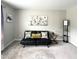 Inviting living room with a black leather futon, soft carpet, and natural light at 1116 Powder, Fuquay Varina, NC 27526