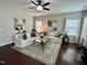 Inviting living room with white sofas, dark wood floors, and an area rug, perfect for entertaining and relaxation at 1116 Powder, Fuquay Varina, NC 27526