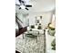 Well-decorated living room with a large sofa, coffee table, and windows, providing ample natural light and a cozy atmosphere at 1116 Powder, Fuquay Varina, NC 27526