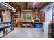 Unfinished basement workshop with tool storage, work benches, and natural light from the window at 112 Hidden Bluff Ln, Cary, NC 27513