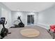 Basement with exercise equipment and sliding glass door to backyard at 112 Hidden Bluff Ln, Cary, NC 27513