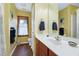 Bright bathroom with wooden cabinets, white countertop, and a window at 112 Hidden Bluff Ln, Cary, NC 27513