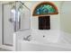 Bathroom showcasing a soaking tub, walk-in shower, and natural light for a spa-like experience at 112 Hidden Bluff Ln, Cary, NC 27513