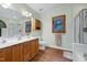 Bathroom featuring double sink, walk-in shower, soaking tub, natural light, and updated fixtures at 112 Hidden Bluff Ln, Cary, NC 27513