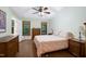 Cozy bedroom featuring natural light, wood flooring, matching furnishings and decor and a ceiling fan at 112 Hidden Bluff Ln, Cary, NC 27513