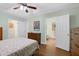 Inviting bedroom with natural light, wood flooring, matching furnishings and decor and a ceiling fan at 112 Hidden Bluff Ln, Cary, NC 27513