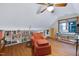 Bonus room featuring an arm chair and built-in bookcase and a hardwood floor at 112 Hidden Bluff Ln, Cary, NC 27513