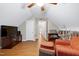 This bonus room offers hardwood floors, a TV, bookshelves and lots of storage at 112 Hidden Bluff Ln, Cary, NC 27513